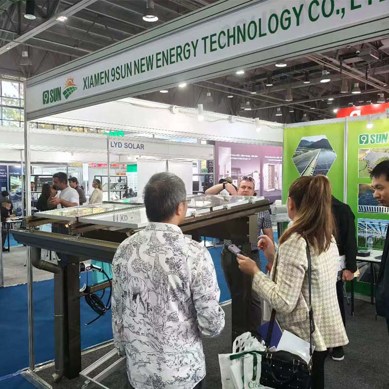 Visitors discussing a solar carport structure at the 9SUN booth, UzEnergy Expo 2026 Visitors discussing a solar carport structure at the 9SUN booth, UzEnergy Expo 2026